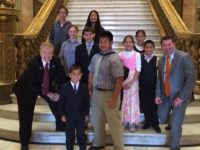 Rep. Patrick Neville right and his father Sen. Tim Neville pose with kids touring the State Capitol during the last session. Representative Neville is concerned about the kids in his district if a union-backed slate of candidates are elected to the school board.