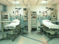 ^BEmergency room.^b View of an empty hospital accident and emergency room. This area, also known as a Casualty department, is prepared for the arrival of anyone who needs urgent medical attention. The beds are surrounded by equipment used for monitoring a patient's health. The condi- tions treated range from light injuries to heart failure. The staff in such areas are trained in a wide range of first aid and emergency procedures.