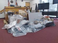 A pile of evidence sits in the middle of a Greeley court room were a man is on trial for the double murder of his ex-girlfriend and another man.