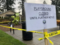 Police caution tape surrounds a playground in Lake Oswego, Ore., on Tuesday, March 24, 2020, the day after Gov. Kate Brown issued a statewide stay-at-home order that closed many businesses, as well as all playgrounds, basketball courts and sport courts.  As families across the country and the globe hunker down at home, it's another danger, equally insidious if less immediately obvious, that has advocates deeply concerned: A potential spike in domestic violence, as victims spend day after day trapped at home with their abusers. (AP Photo/Gillian Flaccus)