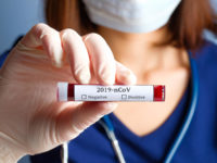 Nurse holding test tube with blood for 2019-nCoV analyzing. Novel Chinese Coronavirus blood test concept