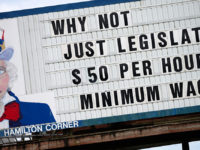 A billboard in Hamilton Corner, Chehalis, Washington pictured on May 2nd 2014 reads, "Why not just legislate $50 an hour minimum wage?" Mayor of Seattle Ed Murray on Thursday proposed a compromise plan for the city which will see the minimum wage climb to $15 an hour over three to seven years depending on business size and benefits. (Photo by: Alex Milan Tracy/Sipa USA) (Newscom TagID: sipaphotosfour717019.jpg) [Photo via Newscom]